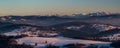 Nearer hills of Beskid Zywiecki mountains and peaks of Tatra mountains on the background from Tyniok hill in winter Beskid Slaski