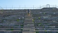 Solitary Runner jogs up the lonely stairs at the site of the Nuremburg Rallies with Hitler in the 1930`s