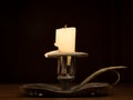 Nearly burnt down candle on old candle holder Royalty Free Stock Photo