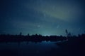 Long exposure night shot featuring star trails, lake, reflection and a little cloud Royalty Free Stock Photo