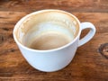 Nearly Empty Coffee Mug on a Wooden Background