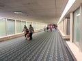 A nearly empty Orlando International Airport with people social distancing and wearing face masks