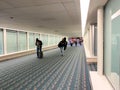 A nearly empty Orlando International Airport with people social distancing and wearing face masks