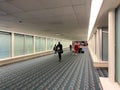 A nearly empty Orlando International Airport with people social distancing and wearing face masks