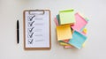 Checklist on Clipboard With Pen and Colorful Sticky Notes on White Background Royalty Free Stock Photo