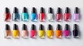 A neat array of colorful nail polish bottles in various shades neatly aligned on a white background, showcasing a spectrum of Royalty Free Stock Photo