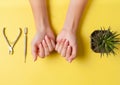 Neat beautiful french manicure on the hands of a young woman. Tool for cutting nails. Minimalism concept for nail care Royalty Free Stock Photo