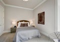 Neat bedroom interior in gray and brown tones Royalty Free Stock Photo