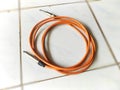 neat circular brown jack cable on the floor Royalty Free Stock Photo