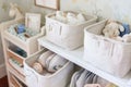 neat fabric storage baskets in a nursery with baby items