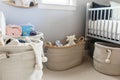 neat fabric storage baskets in a nursery with baby items