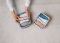 a neat housewife puts things in a laundry container during general cleaning with the help of a modern storage system