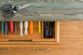 Neat line of colorful knives in a fitted drawer