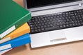 Neat office desk with laptop and stacked folders Royalty Free Stock Photo