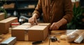 Neat packaging: Close-up depicts skilled hands arranging items thoughtfully into a packing box.