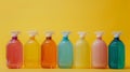 Colorful plastic spray bottles lined up against a vibrant yellow background Royalty Free Stock Photo