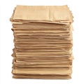 A neat stack of brown paper bags rests on a clean white surface, showcasing their simple design and texture. Royalty Free Stock Photo