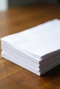 Neat stack of crisp white printer paper on wood, new, pile, white Royalty Free Stock Photo