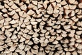 Neat stack of cut wood, textured background Royalty Free Stock Photo