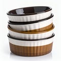 Stacked ramekins offer versatile baking options for culinary enthusiasts on white background Royalty Free Stock Photo