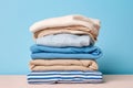 neat stack of white and blue shirts, along with other garments, hanging on table. Image exudes sense of order and style Royalty Free Stock Photo