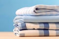 neat stack of white and blue shirts, along with other garments, hanging on table. Image exudes sense of order and style, as shirts Royalty Free Stock Photo