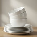 A neat stack of white ceramic dinnerware is displayed, featuring several bowls Royalty Free Stock Photo