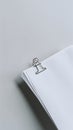 Neat stack of white papers with silver clip on gray background Royalty Free Stock Photo