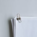 Neat stack of white papers with silver clip on gray background Royalty Free Stock Photo