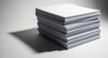 A neat stack of white printer paper sits on a flat surface, casting a shadow to the left. Royalty Free Stock Photo