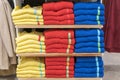 Neat stacks of folded clothing on the shop shelves. Color folding shirt In a neatly organized clothing store