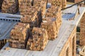 Neat stacks of red bricks lit by summer sun piled on basement fl Royalty Free Stock Photo