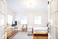 Neat white bedroom with wooden furniture