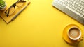 Neat Yellow Office Desk Setup With Computer, Notebook, Pen, and Coffee Cup Royalty Free Stock Photo