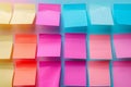 Neatly arranged blank post it notes on wall create visually pleasing grid pattern