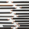 A neatly arranged collection of graphite pencils displayed horizontally on a white Royalty Free Stock Photo