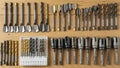 A neatly arranged collection of various drill bits on a wooden surface Royalty Free Stock Photo