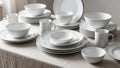 A neatly arranged display of elegant white ceramic tableware on a tabletop. The set includes dinner Royalty Free Stock Photo