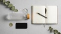 A neatly arranged flat lay features an open notebook with blank pages and a Royalty Free Stock Photo