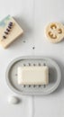 Neatly arranged flat lay featuring bathroom essentials. A white rectangular soap rests Royalty Free Stock Photo