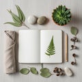 A neatly arranged flat lay on a light wooden surface features an open notebook with a Royalty Free Stock Photo