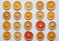 A neatly arranged grid of dried citrus fruit slices displayed on a flat Royalty Free Stock Photo