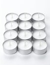Neatly Arranged Group of White Tea Light Candles on White Surface Royalty Free Stock Photo