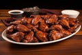 a neatly arranged platter of barbecue chicken wings