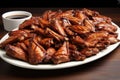 a neatly arranged platter of barbecue chicken wings