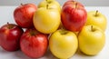 A neatly arranged pyramid of apples is displayed on a white Royalty Free Stock Photo