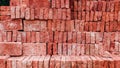 Neatly arranged red bricks and ready for sale