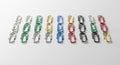 Neatly arranged rows of colored paperclips on a white surface. Five rows display clips in silver, Royalty Free Stock Photo
