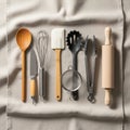 A neatly arranged set of kitchen utensils on a light fabric background Royalty Free Stock Photo