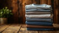 Stack of Folded T-Shirts on Wooden Surface Royalty Free Stock Photo